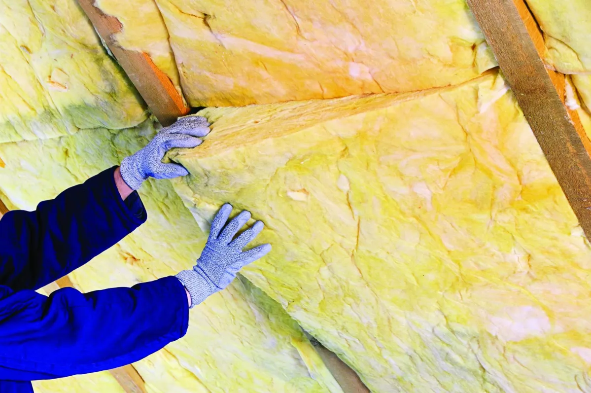 man installing insulation