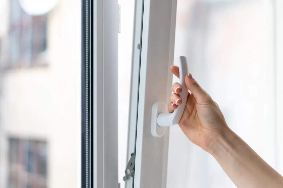 woman opening double-glazed window