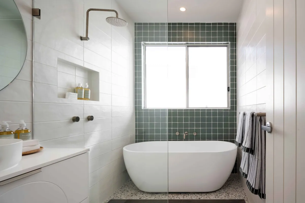 freestanding bathroom in a smaller bathroom, situated within a walk-in shower to save on space.