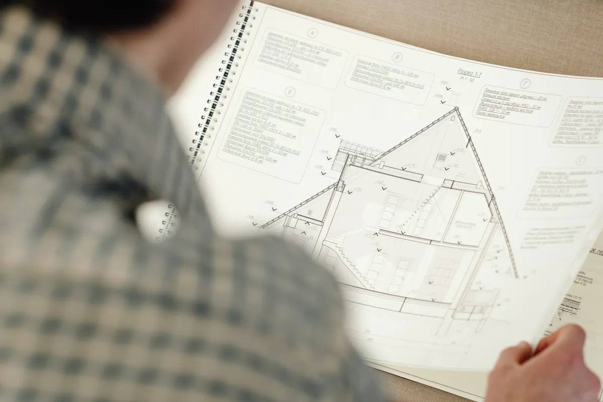 person looking at home plans