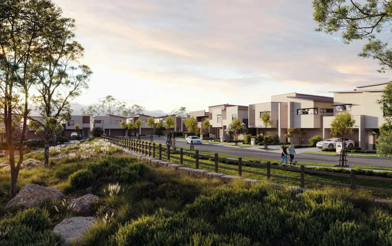 Architectural rendering of Cascadia Estate, a modern residential development featuring contemporary townhouses with cream and dark facades, surrounded by native landscaping, eucalyptus trees, and black fencing, with residents walking and cycling along tree-lined streets at dusk.