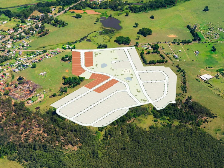 Aerial view of Millfield Rise Estate showing a large commercial development with red-roofed buildings and expansive parking areas surrounded by green fields, trees, and residential properties.