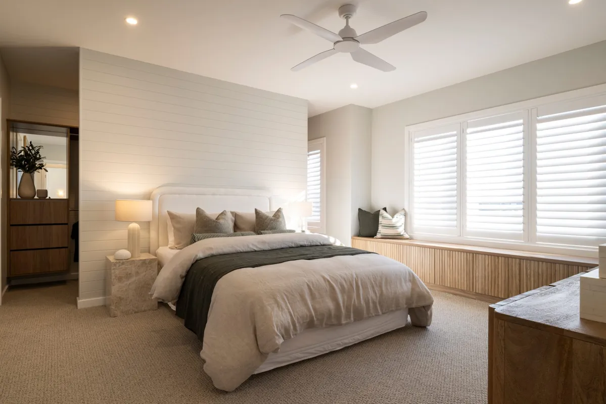 Hamptons-style master bedroom with reclaimed timber accents and soft, neutral linens