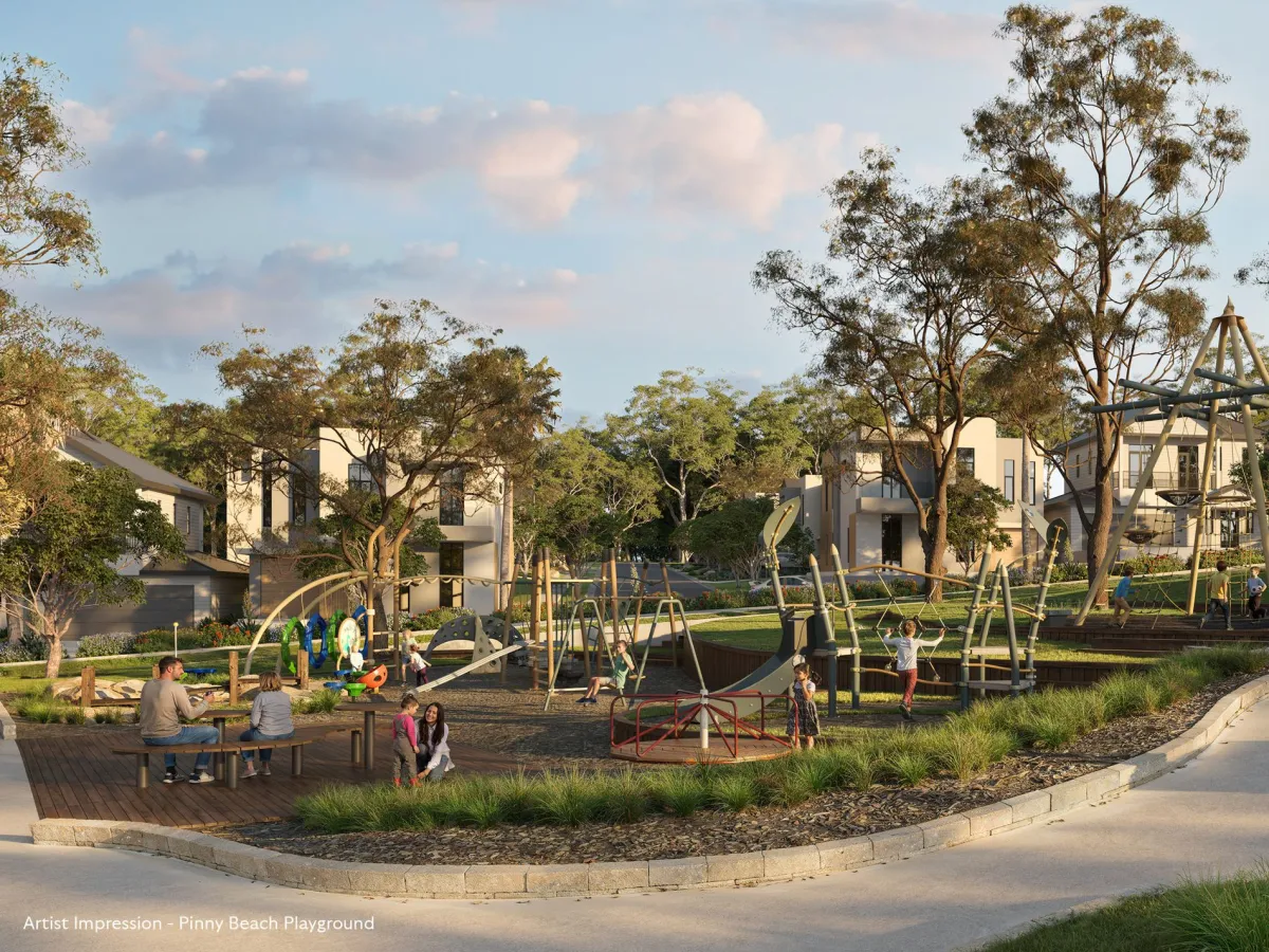 Artist impression of Pinny Beach Playground featuring children playing on modern climbing structures and equipment, with wooden picnic tables in foreground, tall eucalyptus trees throughout, and residential buildings visible in background under blue sky.