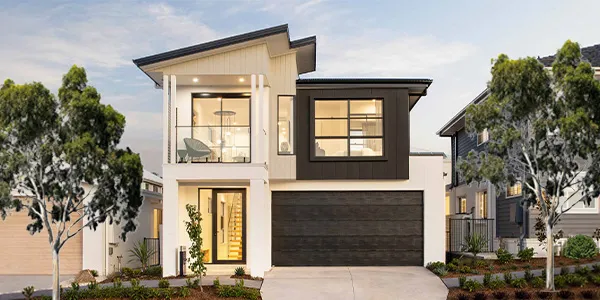 Modern two-story display home with contemporary architecture featuring a split facade of cream and black exterior, large windows, dark garage door, and landscaped front yard with young trees and shrubs in Leppington.