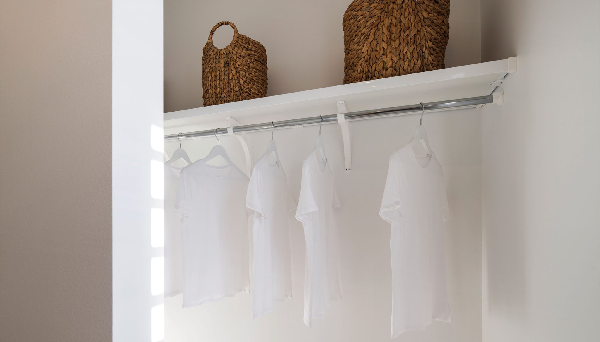 Bedrooms: White shelf and rail to other bedrooms