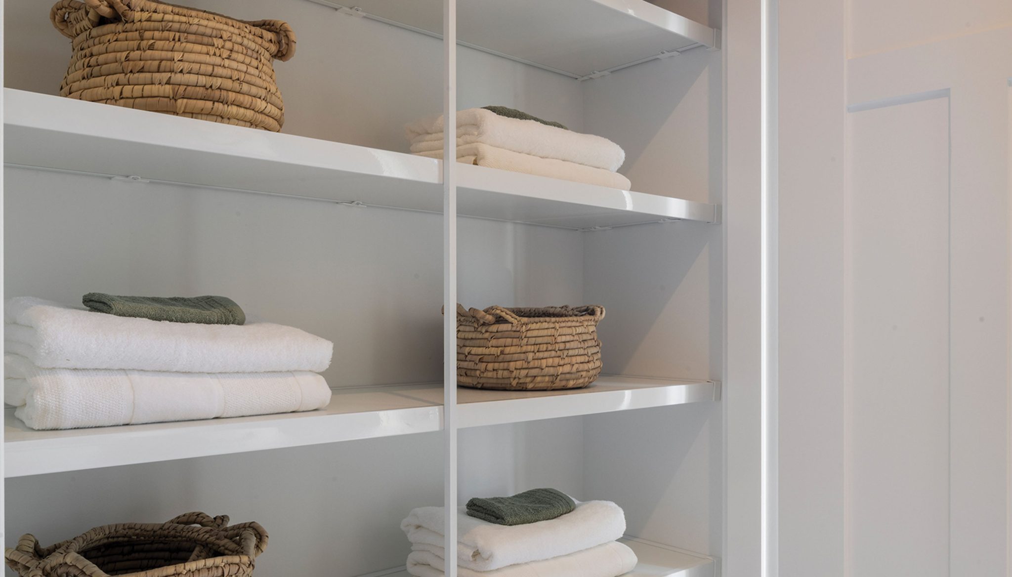 Living area: White shelves to linen cupboard